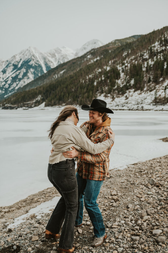 Surprise Montana Proposal in Northwest Montana | Western Engagement Outfit Inspiration | Western Photographer| Snowy Mountain Proposal | Engagement ring | Ranch Water | Montana Brewing Company